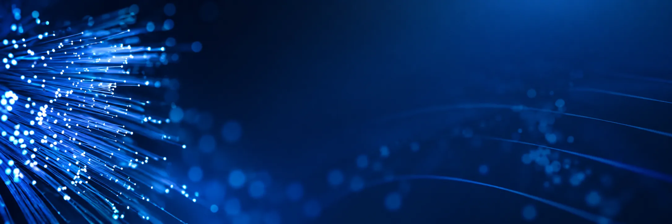 Glowing optical fiber tips against a blue gradient, conceptual illustration